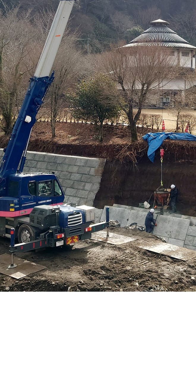 工事の様子。青い重機と黄色の重機を使って工事している写真